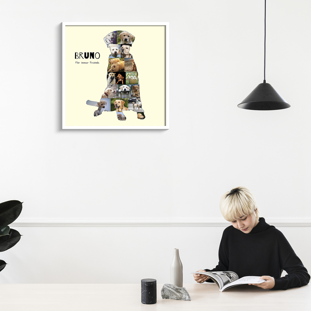 Fotocollage als sitzende Labrador-Silhouette mit Namen und Wunschtext, im weißen Rahmen an heller Wand über dem Tisch